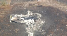 Aerial view of a burned-out airplane at London Southend Airport.