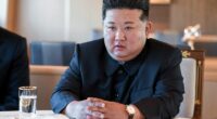Kim Jong Un sitting at a table.