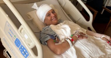 Woman in hospital bed recovering from dog attack.