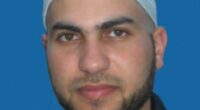 Headshot of a man wearing a kufi.