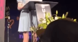 Woman giving a speech at a podium.