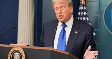 President Donald Trump speaking at a podium.