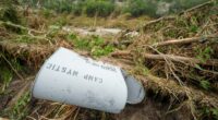 Damaged Camp Mystic mailbox in flood debris.
