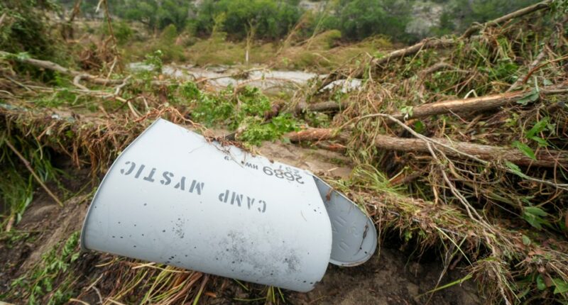 Damaged Camp Mystic mailbox in flood debris.