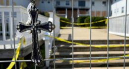 Jeweled cross at a fire memorial.
