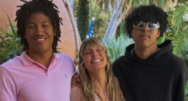 Heidi Klum is dwarfed by sons Henry, 19, and Johan, 18