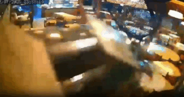 Security camera footage of a blurry altercation in a restaurant.