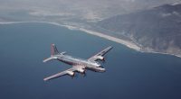 American Airlines Douglas DC-4 airplane in flight over ocean.