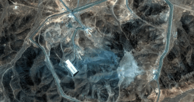 Aerial view of a fenced-in facility in a desert landscape.