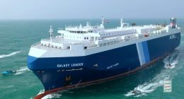 The Galaxy Leader cargo ship escorted by small boats in the Red Sea.