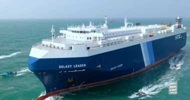 The Galaxy Leader cargo ship escorted by small boats in the Red Sea.