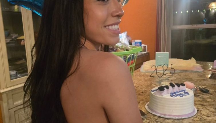 Photo of Marissa DiNapoli with balloons and a birthday cake.