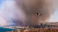 Smoke from a massive wildfire obscuring a city.