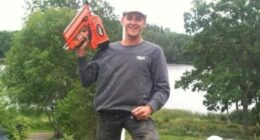 Photo of Glen Godfrey holding a nail gun.
