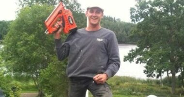 Photo of Glen Godfrey holding a nail gun.