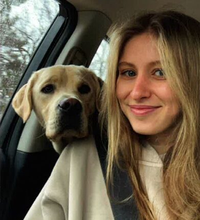 Eliotte Heinz and her dog in a car.