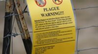 A sign warning of bubonic plague is displayed at a parking lot near the Rocky Mountain Arsenal Wildlife Refuge in Commerce City, Colorado, USA.