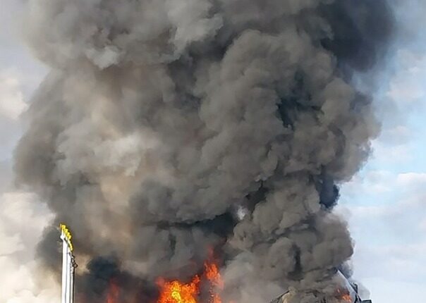Large fire and smoke billowing from a burning vehicle.