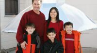 The Heene family smiles together in coordinating red outfits.