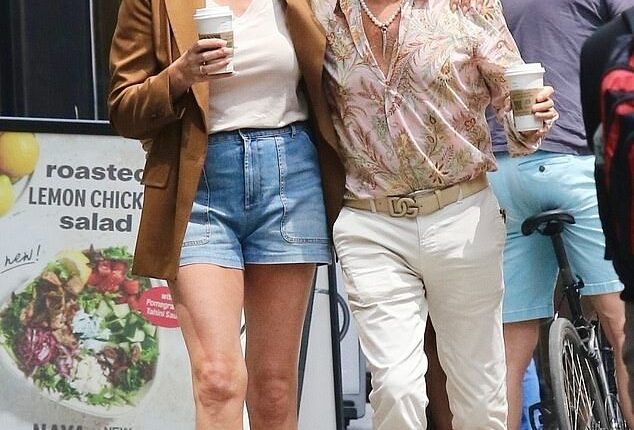 Rocker Rod Stewart and his wife Penny Lancaster looked madly in love as they cosied up during a stroll in New York City