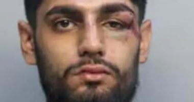 Mugshot of Ishaan Sharma with a black eye and other injuries.