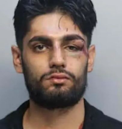 Mugshot of Ishaan Sharma with a black eye and other injuries.