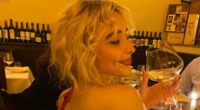 Sabrina Carpenter goes bra-free in a backless ruby red dress