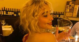 Sabrina Carpenter goes bra-free in a backless ruby red dress