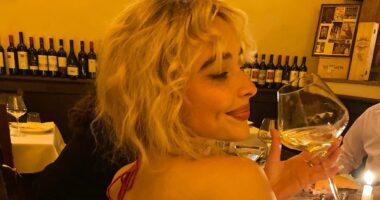 Sabrina Carpenter goes bra-free in a backless ruby red dress
