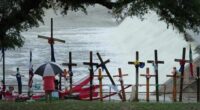 Rain falls over a make-shift memorial for flood victims along the Guadalupe River, Sunday, July 13, 2025, in Kerrville, Texas.