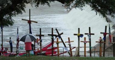 Rain falls over a make-shift memorial for flood victims along the Guadalupe River, Sunday, July 13, 2025, in Kerrville, Texas.