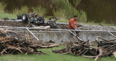 A man surveys debris and flood damage along the Guadalupe River, Sunday, July 13, 2025, in Kerrville, Texas. (AP Photo/Eric Gay)
