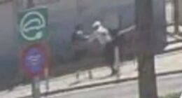 Low-quality security camera footage of a mugging.