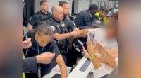 Airport security subdues a disruptive passenger.
