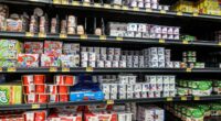 Walmart dairy aisle with various yogurts on shelves.