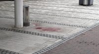 Blood stain on a sidewalk after a stabbing.