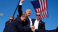 Former President Trump is surrounded by Secret Service agents after an assassination attempt at a campaign rally in Butler, Pa. on July 13. Associated Press/Evan Vucci