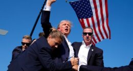 Former President Trump is surrounded by Secret Service agents after an assassination attempt at a campaign rally in Butler, Pa. on July 13. Associated Press/Evan Vucci