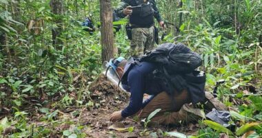 Thai forces examine a landmine near the Cambodian border.