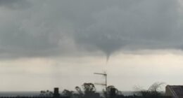 Waterspout over rooftops.
