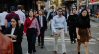 Pedestrians and office workers walk through the Sydney CBD.