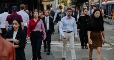 Pedestrians and office workers walk through the Sydney CBD.