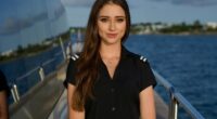 Portrait of a young woman in a yacht crew uniform.