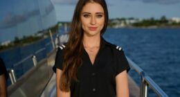 Portrait of a young woman in a yacht crew uniform.