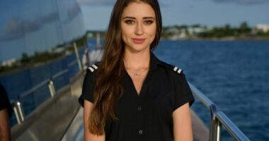 Portrait of a young woman in a yacht crew uniform.