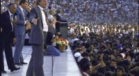 Jimmy Swaggart preaching to a large crowd.