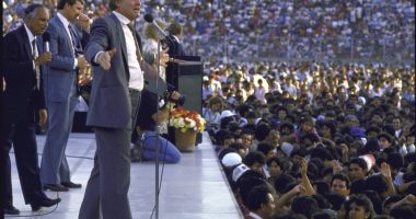 Jimmy Swaggart preaching to a large crowd.