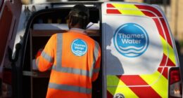 Man at back of van with Thames Water logo