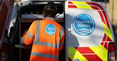 Man at back of van with Thames Water logo