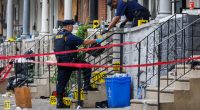 Crime scene investigators collecting evidence at a shooting scene.